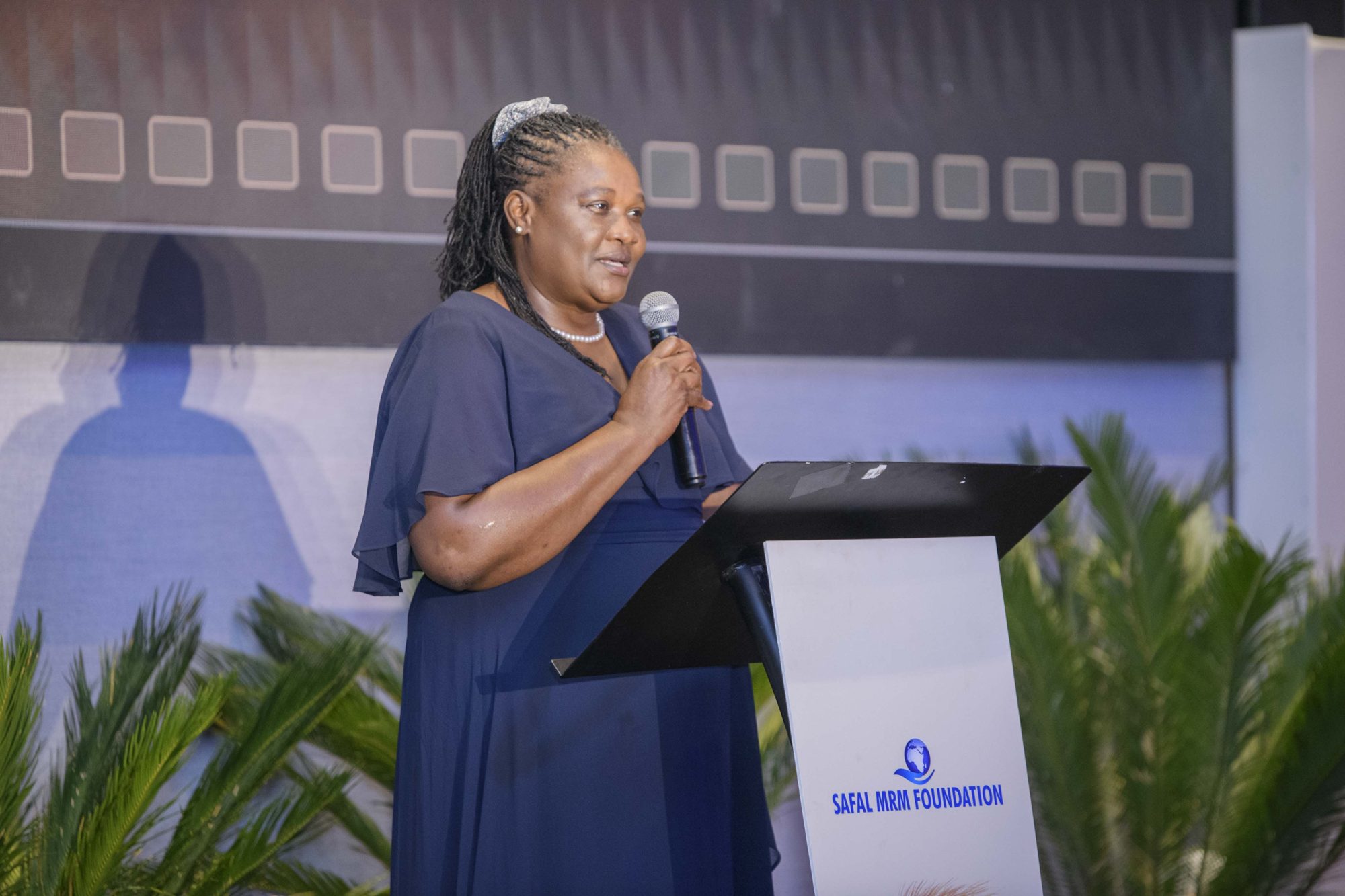 Safal MRM Foundation trustee speaking at a podium during the annual awards evening.